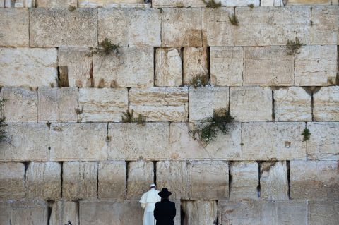 Pope Francis prays next to a rabbi at the Western Wall in Jerusalem's Old City in May 2014. The Pope went on a <a href="http://www.cnn.com/2014/05/24/world/gallery/pope-holy-land/index.html">three-day trip to the Holy Land</a>, and he was accompanied by Jewish and Muslim leaders from his home country of Argentina.