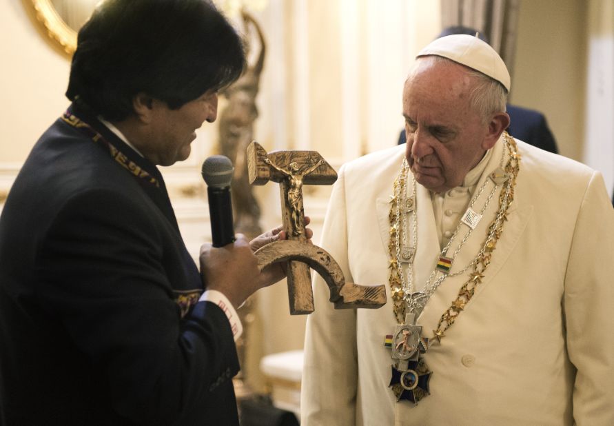 Bolivian President Evo Morales presents the Pope with a gift of a crucifix carved into a wooden hammer and sickle -- the Communist symbol uniting laborers and peasants -- in La Paz, Bolivia, on Wednesday, July 8, 2015.