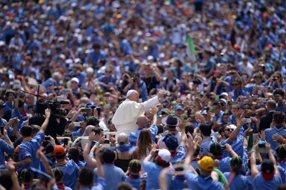 Pope Francis greets a crowd of Italian Catholic boy scouts and girl guides at St. Peter's Square on Saturday, June 13, 2015.