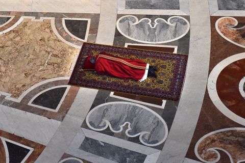 The Pope prays face down on the floor of St. Peter's Basilica during Good Friday celebrations at the Vatican on Friday, April 3, 2015.