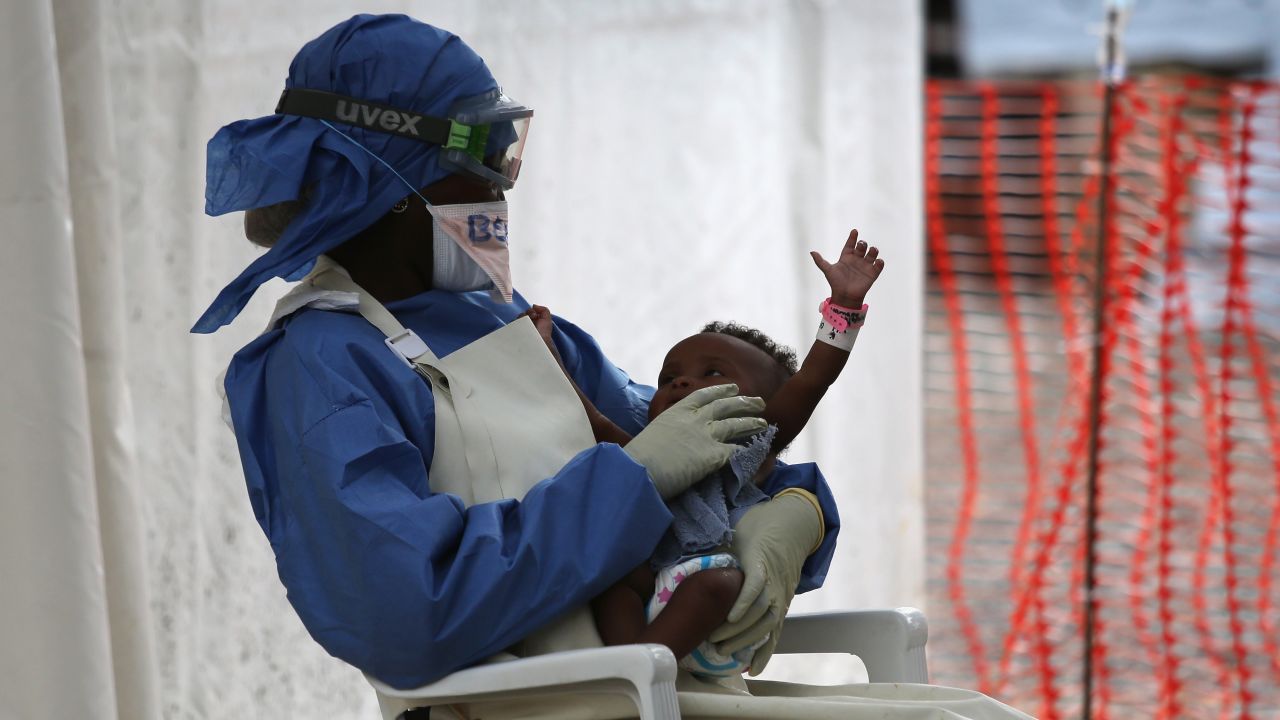 Nurse's aide Benetha Coleman comforts an infant girl thought to have Ebola symptoms in the high-risk area of the Doctors Without Borders' Ebola Treatment Unit in Paynesville, Liberia, in January. The baby's blood test later came back negative.