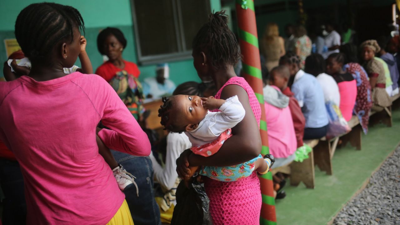 A mother brings her sick child for treatment at Redemption Hospital, formerly an Ebola holding center, in Monrovia in February 2015. Life is slowly returning to normal for many Liberians.
