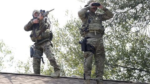 Law enforcement search for suspects.