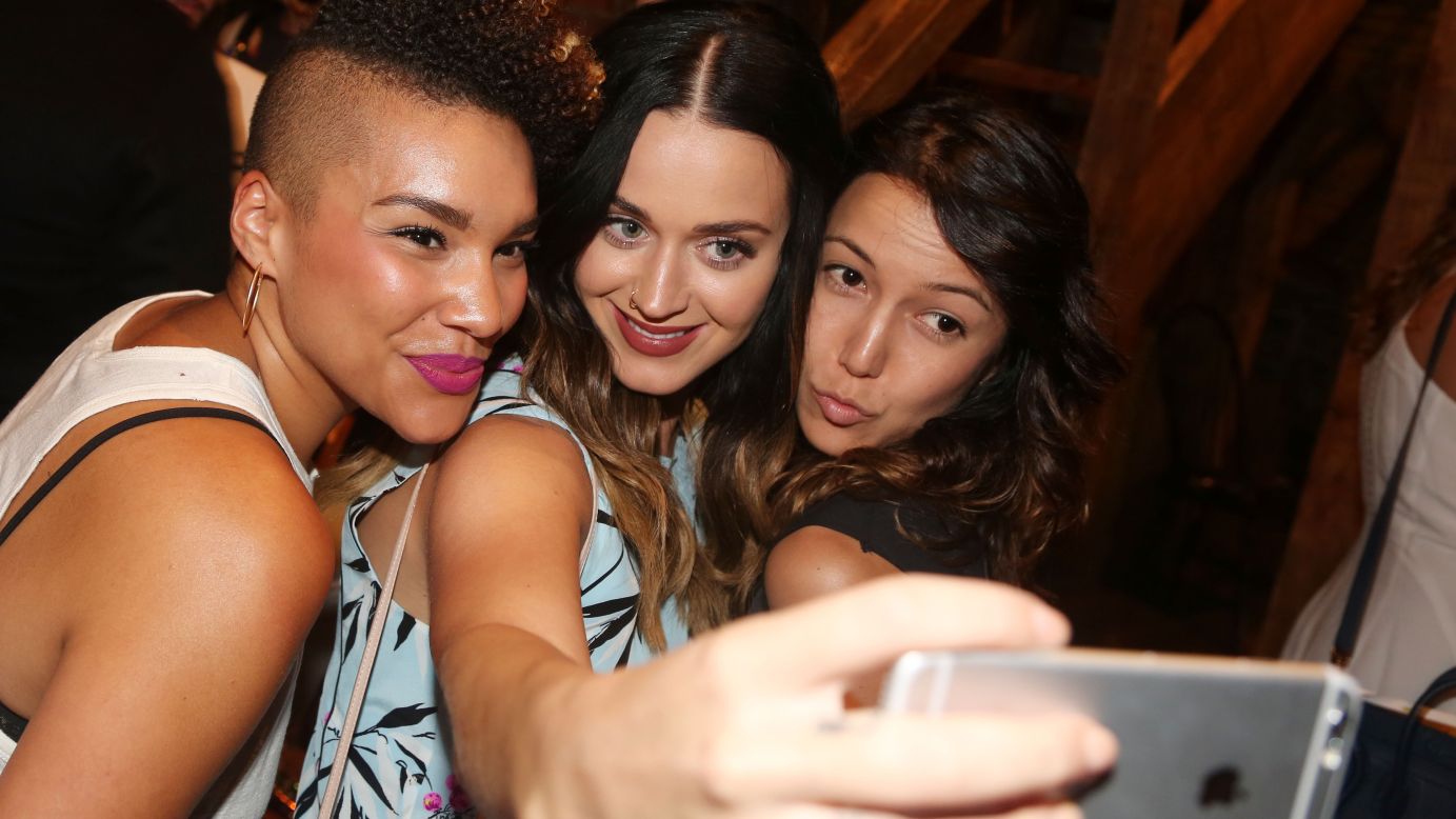 Pop star Katy Perry takes a selfie with Emmy Raver-Lampman, left, and Morgan Marcell as they pose backstage at the Broadway musical "Hamilton" on Thursday, August 27.