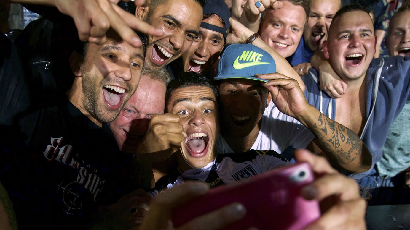Joey Pelupessy, a soccer player with the Dutch club Heracles Almelo, takes a selfie with fans Saturday, August 29, in Almelo, Netherlands.