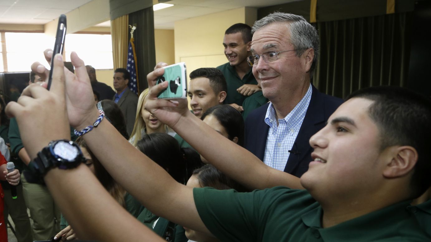Republican presidential candidate Jeb Bush poses for a selfie with a student during a town-hall meeting at a Miami school on Tuesday, September 1.