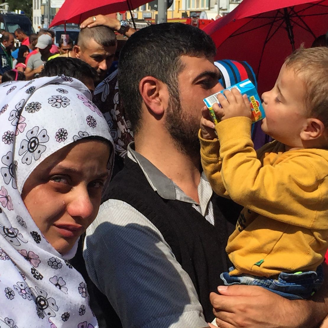 A woman filled with emotion cries at the Munich train station after fleeing Syria.