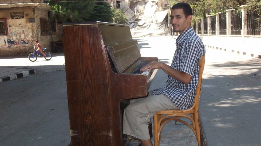 Ahmed plays piano in the middle of Damascus before it was destroyed by ISIS