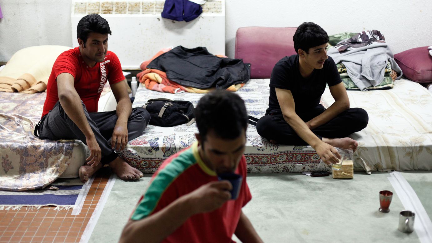 Migrants from Afghanistan drink tea at a Paris school where they found shelter.