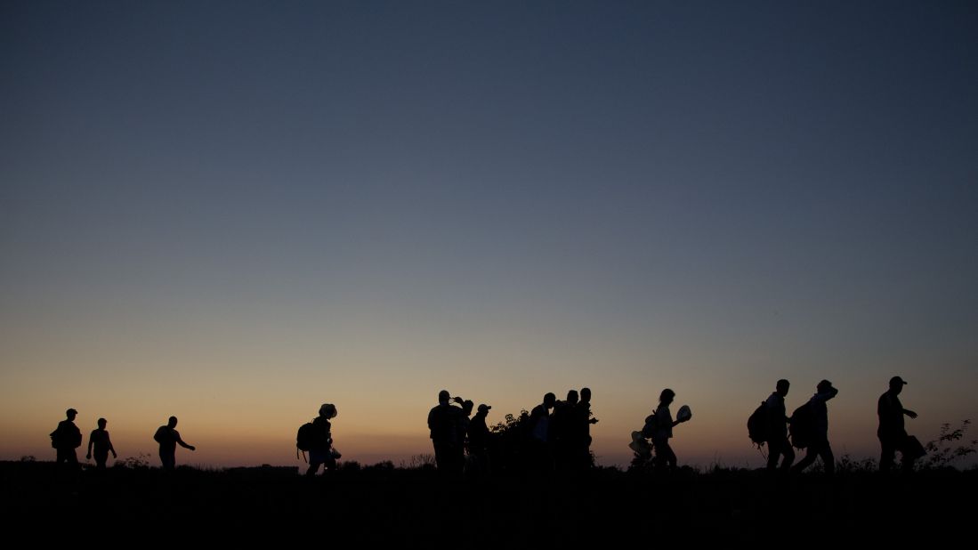 A group of refugees continues its journey through Hungary after crossing the Serbian border.