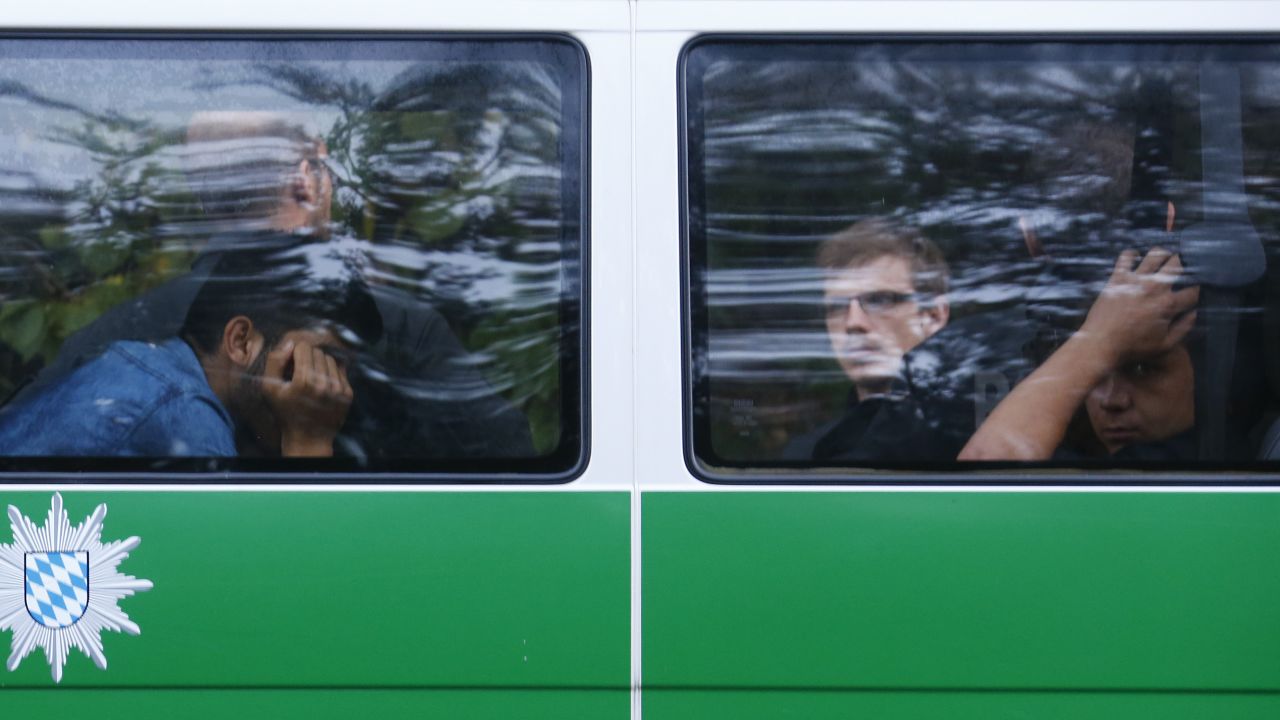 Migrants sit in a police bus in Pocking, Germany, after making their way to the country from Austria.
