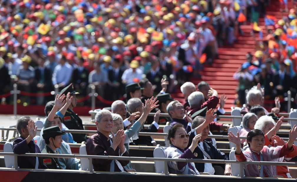 Chinese veterans wave from a bus during the military parade on September 3.