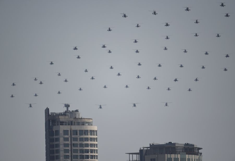 Chinese military helicopters fly in formation during the grand parade on September 3.