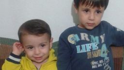 CNN now has a photo of 3-year-old Aylan Kurdi smiling in a little yellow jacket alongside his big brother Galip. Just the way family members and activists want two of the tiniest victims of the refugee tragedy remembered.