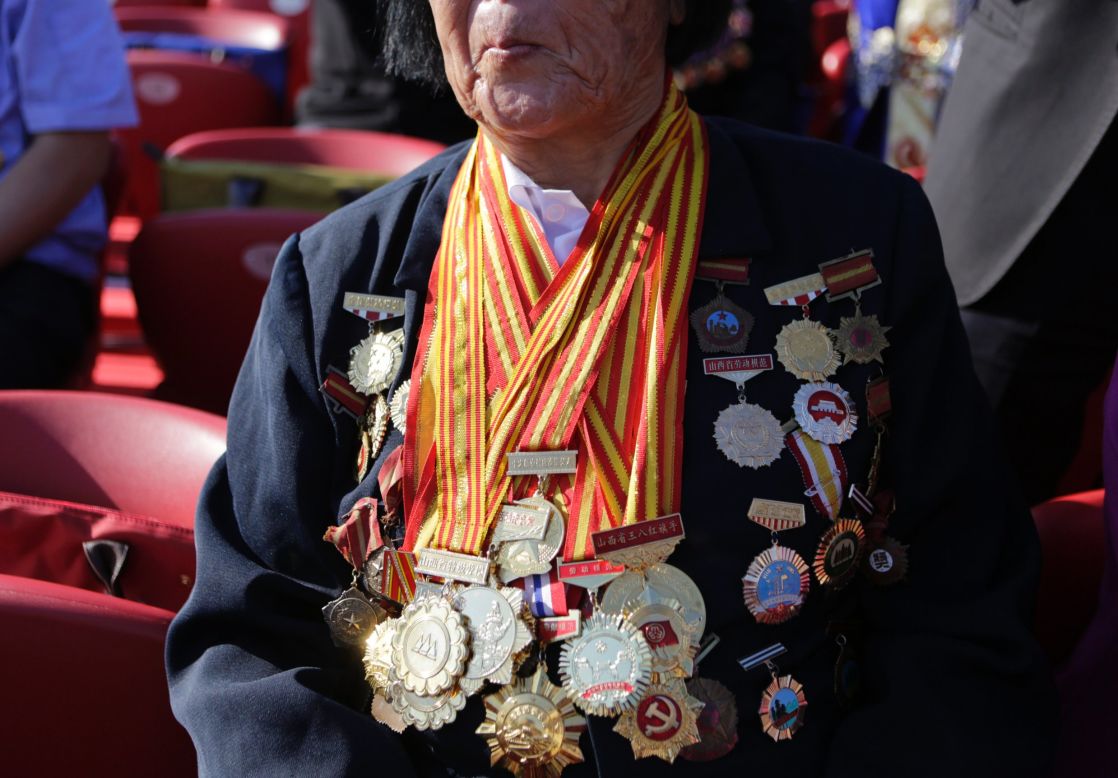 Decorated with medals, 85-year-old Shen Ji-lan prepares for the military parade in Beijing. She is the only person in China to be appointed twelve consecutive times as a member of the National People's Congress, China's legislature, according to local media.