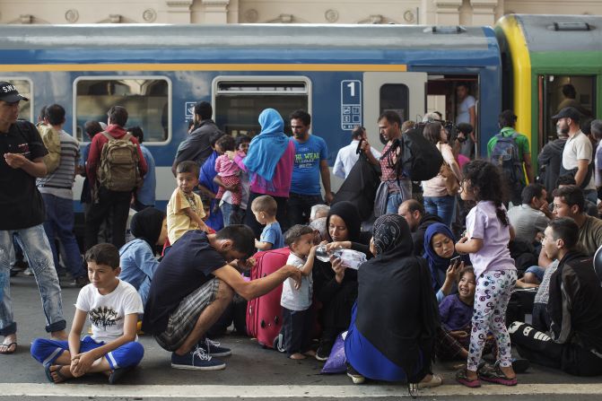 Migrants stand on the platform of the Keleti station waiting for a train. The station has become a focal point of the crisis currently engulfing parts of Europe, as an unprecedented wave of people -- mostly refugees fleeing conflict in Syria, Iraq and Afghanistan -- seek to reach Northern and Western Europe.