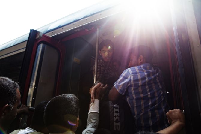 Migrants try to board trains in Budapest.