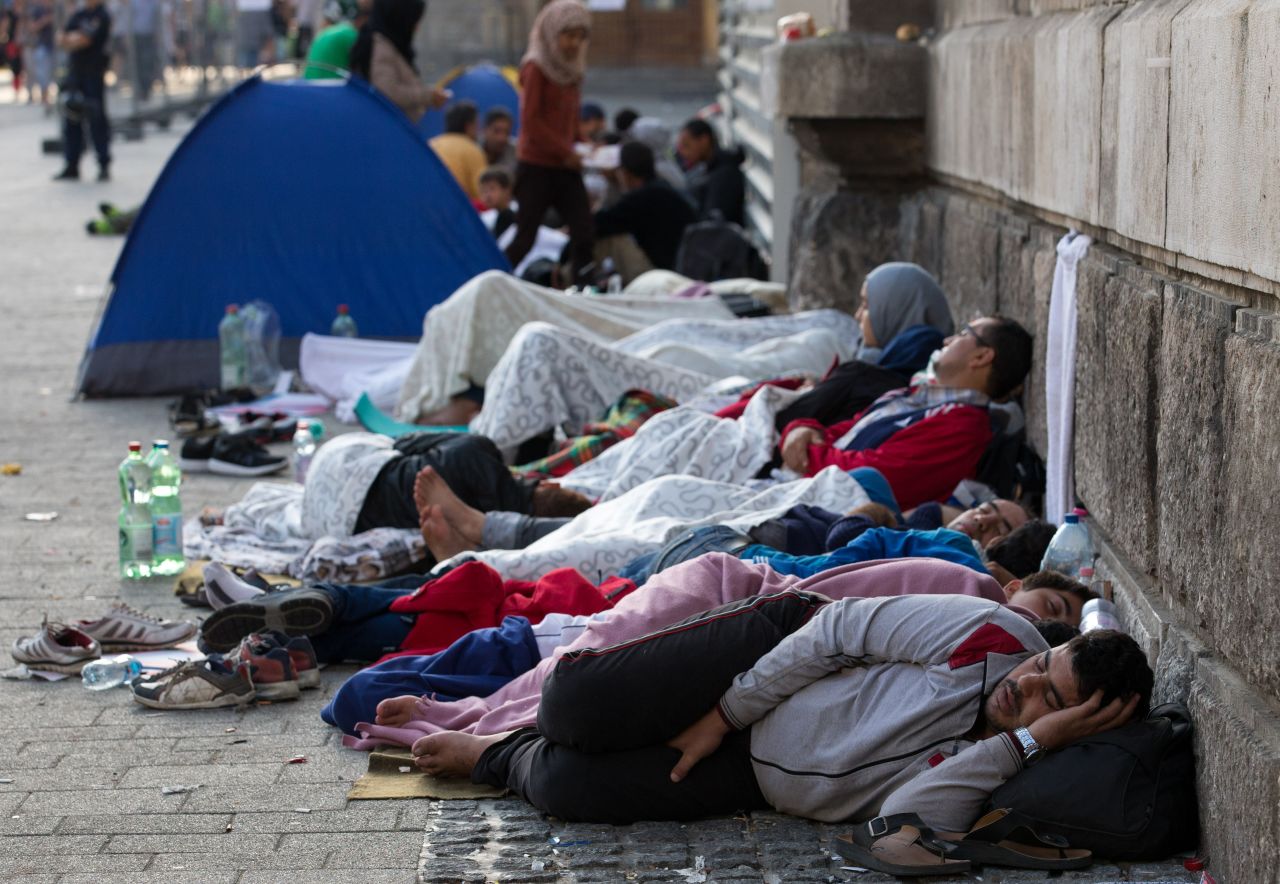 Refugees and migrants sleep outside the station. On Thursday, Hungarian Prime Minister Viktor Orban is meeting with other members of the European Union to figure out how to cope with the emergency.