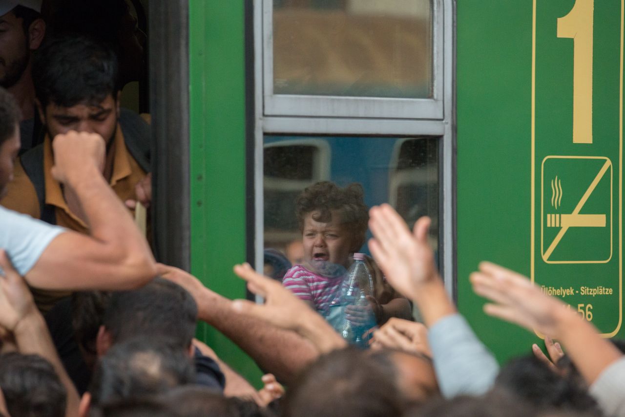 Refugees and migrants board trains in Keleti station after it was reopened in central Budapest.