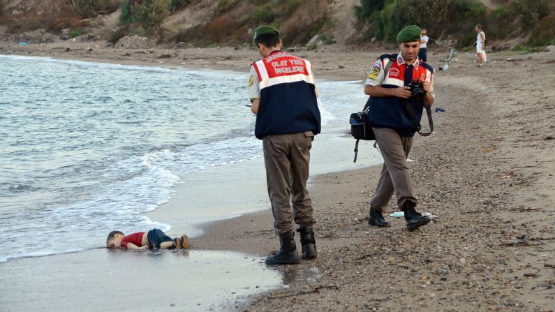 Authorities stand near the body of 2-year-old Alan Kurdi on the shore of Bodrum, Turkey, in September 2015. Alan, his brother and their mother <a href="index.php?page=&url=http%3A%2F%2Fwww.cnn.com%2F2015%2F09%2F03%2Feurope%2Fmigration-crisis-aylan-kurdi-turkey-canada%2Findex.html" target="_blank">drowned while fleeing Syria.</a> This photo was shared around the world, often with a Turkish hashtag that means "Flotsam of Humanity."