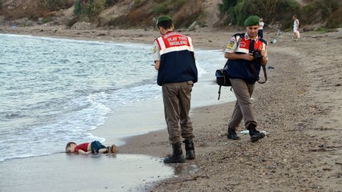 Authorities stand near the body of 2-year-old Alan Kurdi on the shore of Bodrum, Turkey, in September 2015. Alan, his brother and their mother <a href="http://www.cnn.com/2015/09/03/europe/migration-crisis-aylan-kurdi-turkey-canada/index.html" target="_blank">drowned while fleeing Syria.</a> This photo was shared around the world, often with a Turkish hashtag that means "Flotsam of Humanity."
