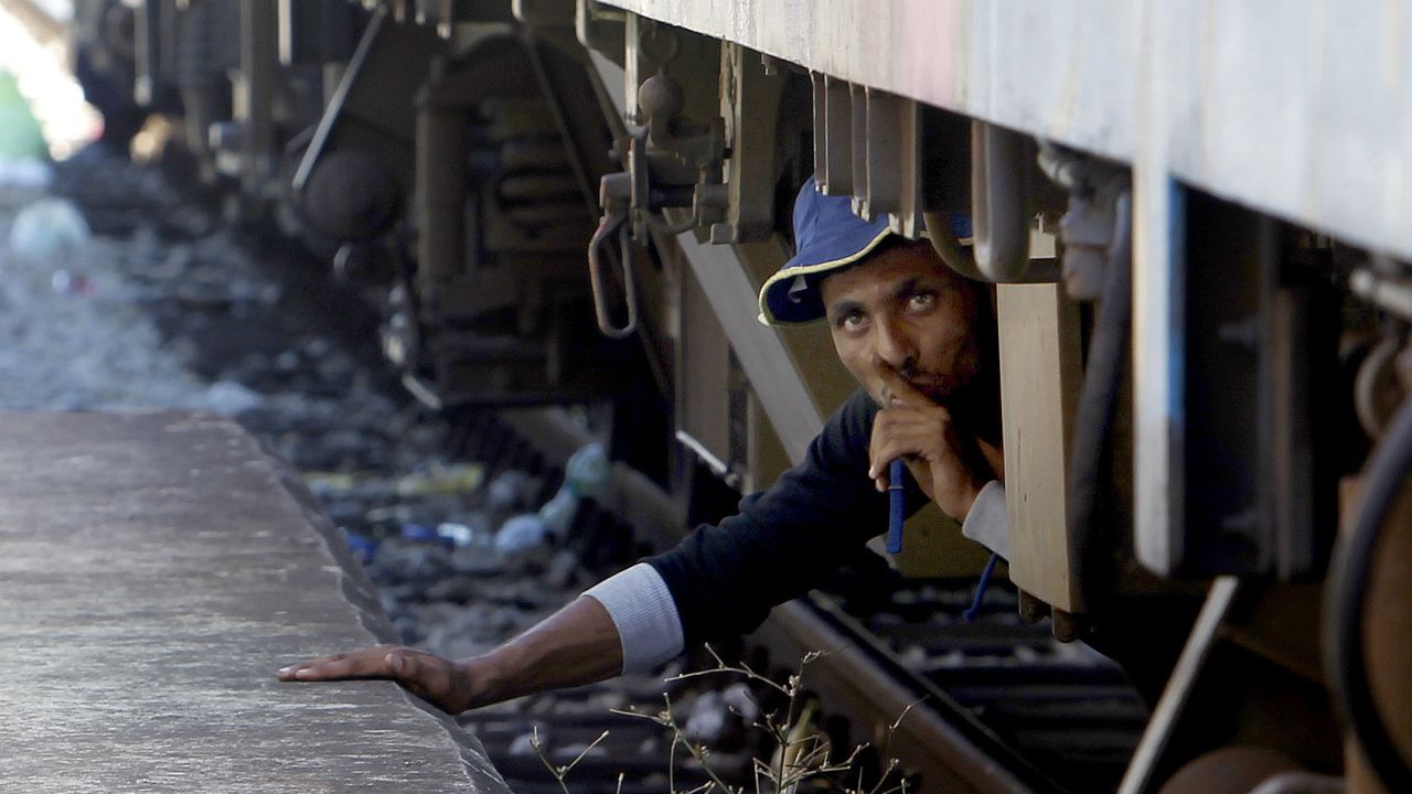 A migrant in Gevgelija, Macedonia, tries to sneak onto a train bound for Serbia in August 2015.