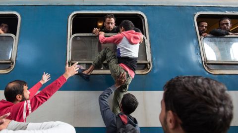 Migrants board a train at Keleti station in Budapest, Hungary, after the station was reopened in September 2015.