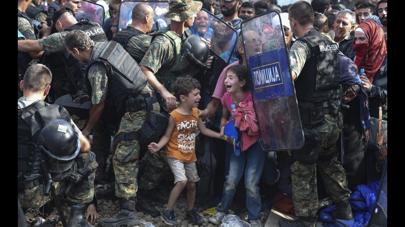 Children cry as migrants in Greece try to break through a police cordon to cross into Macedonia in August 2015. Thousands of migrants -- most of them fleeing Syria's bitter conflict -- were stranded in a <a href="index.php?page=&url=http%3A%2F%2Fwww.cnn.com%2F2015%2F08%2F22%2Feurope%2Feurope-macedonia-migrant-crisis%2F" target="_blank">no-man's land</a> on the border.