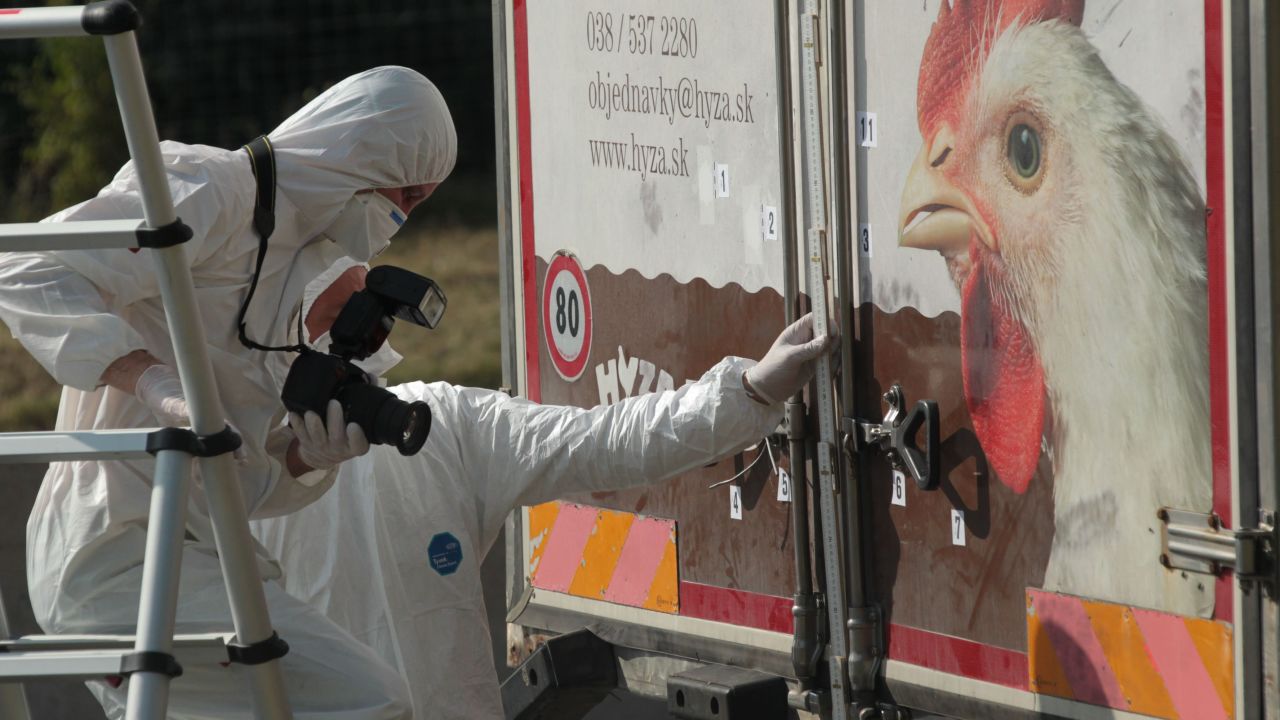 Investigators in Burgenland, Austria, inspect an abandoned truck that contained the bodies of refugees who died of suffocation in August 2015. The 71 victims -- most likely <a href=