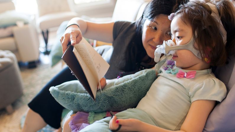 Michelle reads to Julianna. Her mother has made sure Julianna understands that going to heaven means "dying and leaving this Earth." She also told her it meant leaving her family for a while, but they would join her later.