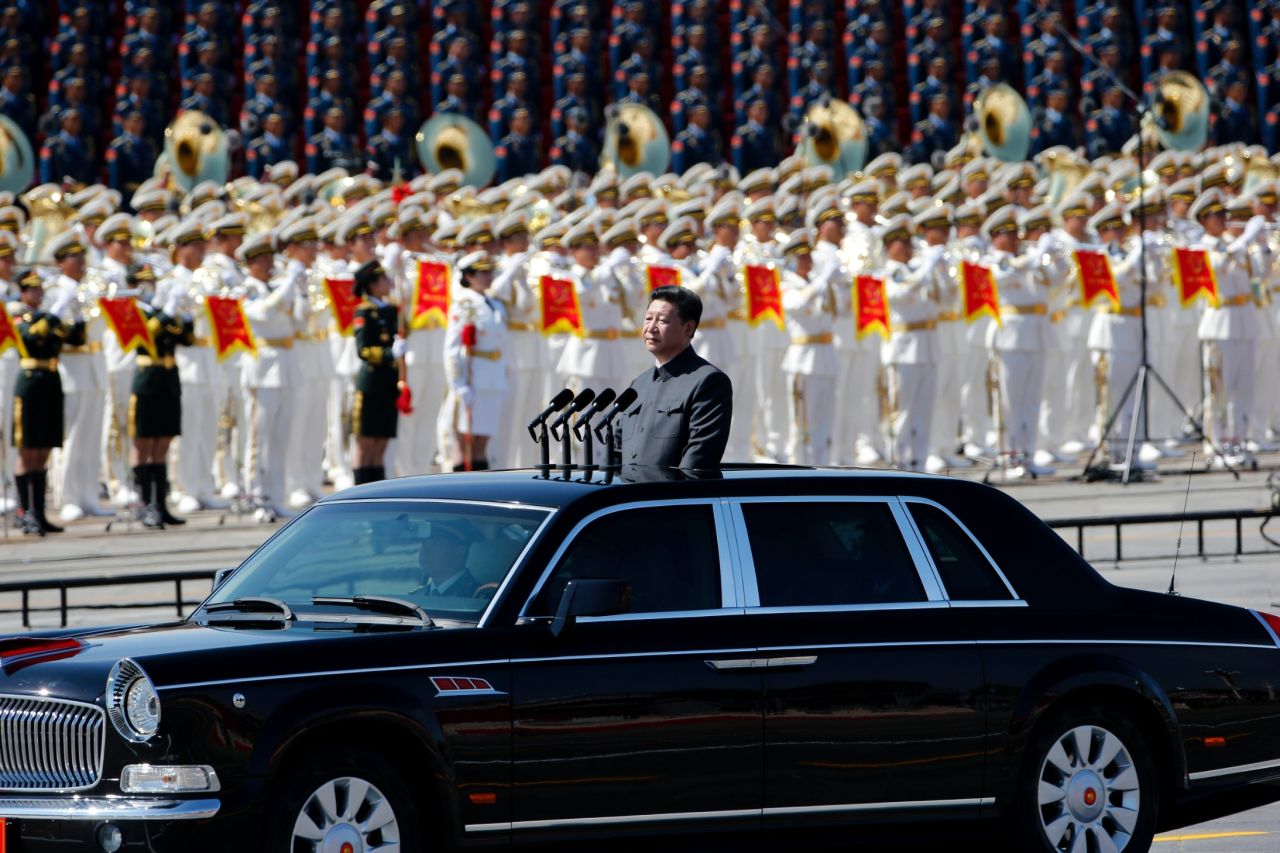 Chinese President Xi Jinping stands in a sedan to address the People's Liberation Army on September 3.