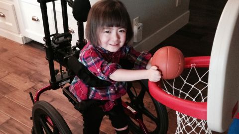 Julianna used to turn circles in her wheelchair. Now her hands are too weak to work the controls. 