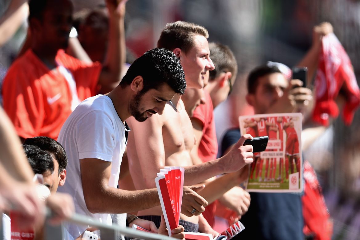 Bayern isn't the only German club helping migrants. Here refugees, invited by  Mainz 05, attend a Bundesliga match against Hannover 96 at Coface Arena in August.