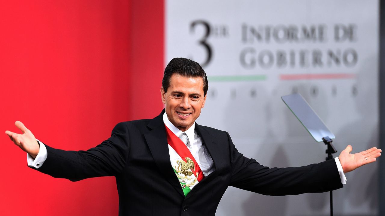 Mexican President Enrique Pena Nieto gestures after delivering his third annual report at the National Palace in Mexico City on September 2, 2015. Mexico's embattled President Enrique Pena Nieto acknowledged his country's "outrage" over a drug kingpin's jailbreak, the presumed massacre of 43 students and other scandals in his state-of-the-nation speech Wednesday. AFP PHOTO/ALFREDO ESTRELLA        (Photo credit should read ALFREDO ESTRELLA/AFP/Getty Images)