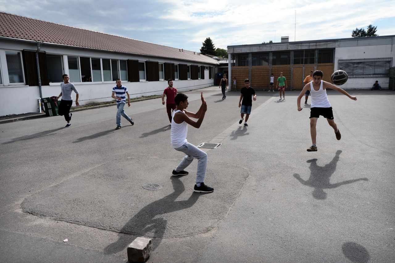 As well as setting up the training camp for kids, Bayern will also offer them meals and German language classes in conjunction with the city of Munich. Here migrants seeking political asylum play football at the registration center on August 26, 2015 in Ingelheim, Germany. 
