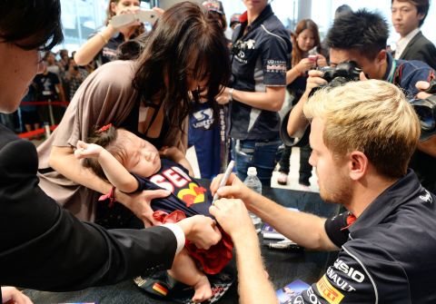 Vettel prefers to shield his young family from the limelight. The German driver is pictured signing autographs for fans in October 2013, when he was at Red Bull.