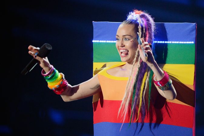 Channeling the 2015 Video Music Award incarnation of Miley Cyrus is arguably less controversial than the 2013 version. Play up the rainbows and stuffed animals and minimize the racial appropriation. Keep the crazy tongue wagging, though.