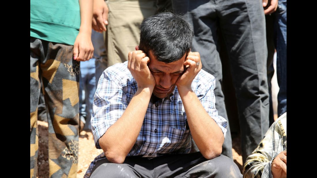 Abdullah Kurdi, the boys' father and widower of Rehen, mourns during the funeral in Kobani on September 4, 2015.