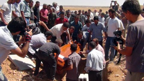 One of the coffins gets lowered into the ground September 4, 2015, in Kobani.