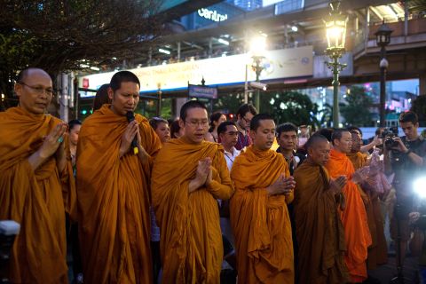 Monks pray at the Erawan Shrine on August 24 to commemorate the victims of the bombing.