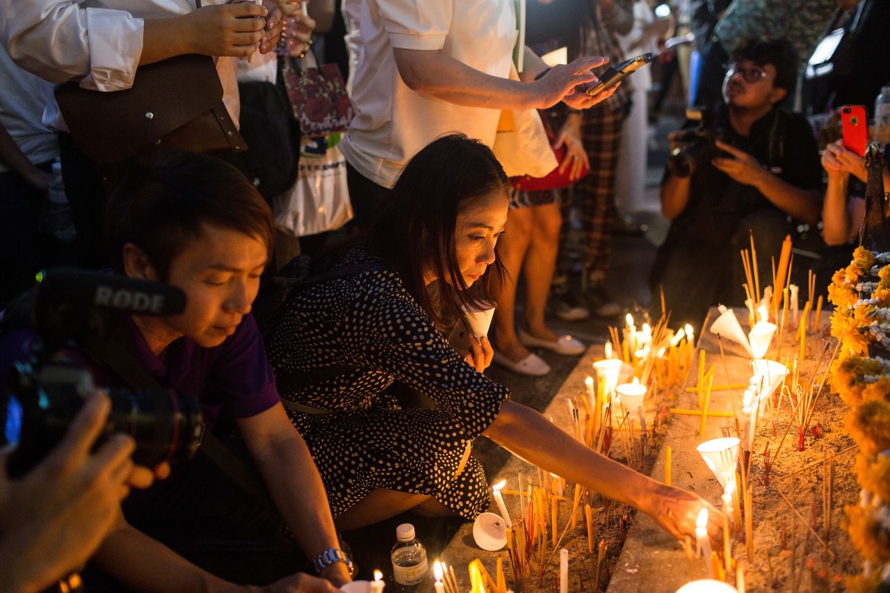 Visitors gather around the base of the Erawan Shrine on August 24, 2015 to commemorate the victims of the bomb attack in Bangkok, Thailand.