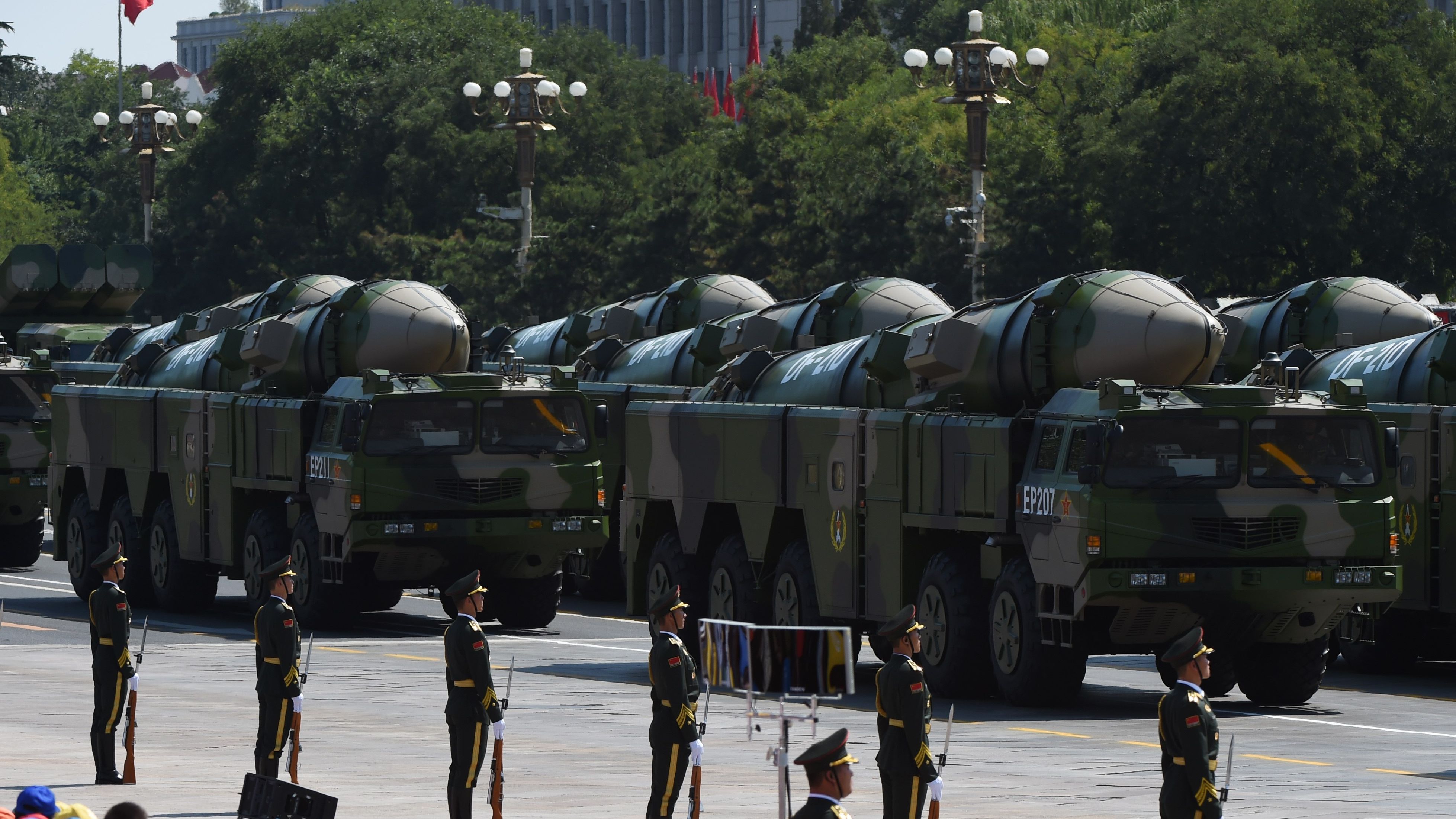 Military vehicles carrying DF-21D missiles, also known as the"carrier-killer" are displayed in a military parade at Tiananmen Square in Beijing on September 3, 2015.