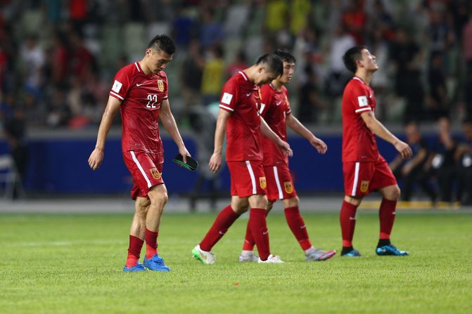 China's disappointed players walk off the pitch after failing to beat Hong Kong.