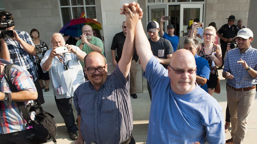 MOREHEAD, KY - SEPTEMBER 04: Michael Long (left) and Timothy Long, of Rowan County, raise their hands in front of a crowd of supporters after receiving their legal marriage license at the Rowan County Courthouse September 3, 2015 in Morehead, Kentucky. Kim Davis, an Apostolic Christian and a Rowan County clerk, refused to issue marriage licenses to same sex couples in defiance of a Supreme Court ruling, citing religious objections. Davis was held in contempt of court and placed in Carter County jail on Thursday, September 3rd. (Photo by Ty Wright/Getty Images)