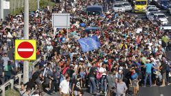 Migrants walk out of Budapest, Hungary, Friday, Sept. 4, 2015. Over 150,000 people seeking to enter Europe have reached Hungary this year, most coming through the southern border with Serbia, and many apply for asylum but quickly try to leave for richer EU countries. (AP Photo/Frank Augstein)