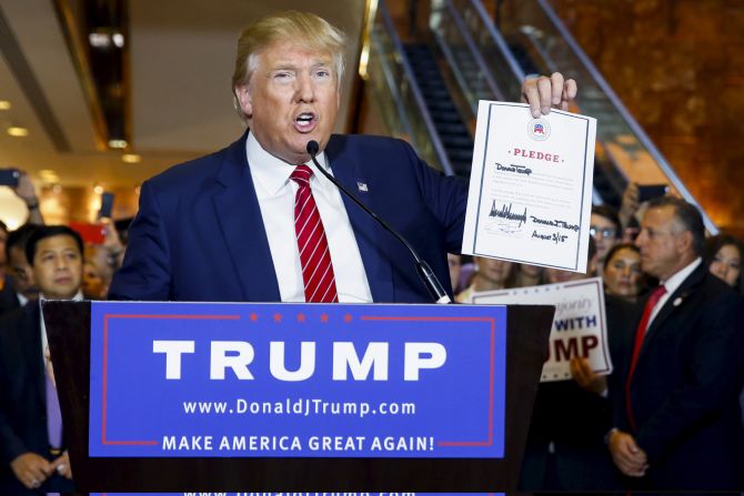 U.S. presidential hopeful Donald Trump <a href="http://www.cnn.com/2015/09/03/politics/donald-trump-2016-rnc-pledge-meeting/" target="_blank">holds up a signed pledge</a> during a press availability at Trump Tower in Manhattan, New York, on Thursday, September 3. 