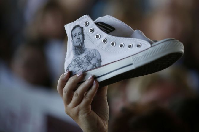 A supporter of presidential hopeful Sen. Ted Cruz holds up a sneaker with Cruz's likeness on it while Cruz visits with supporters during a rally at the Fort Worth Stockyards in Fort Worth, Texas, on Thursday, September 3.