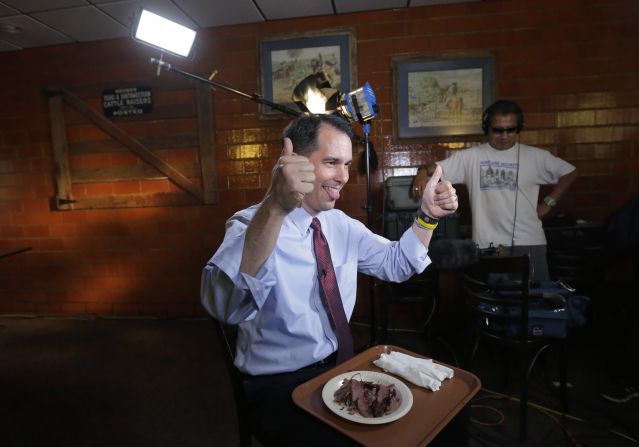 Republican presidential candidate Wisconsin Gov. Scott Walker gives a thumbs up as he does a TV interview during a campaign stop at Bill Miller's Bar-B-Q on Wednesday, September 2, in San Antonio, Texas. 