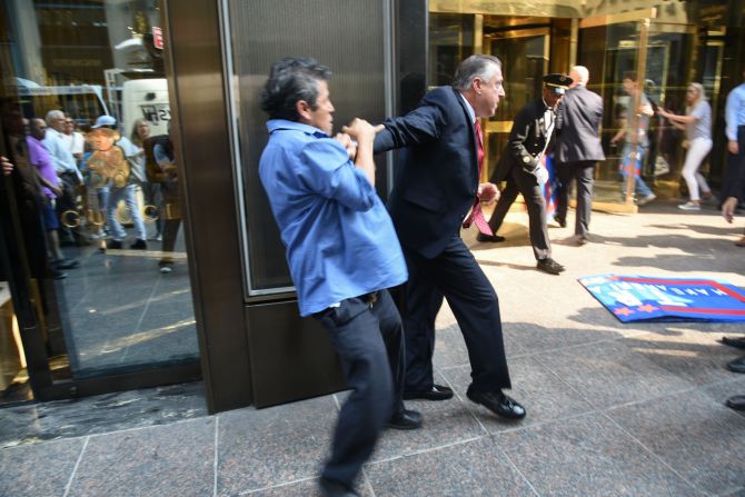 Donald Trump's director of security and longtime bodyguard Keith Schiller holds back  demonstrator Efrain Galicia at Trump Tower in New York on Thursday, September 3. 
