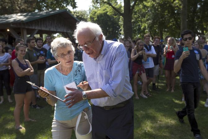  Democratic presidential hopeful Sen. Bernie Sanders talks to Donna Winburn about signing a pledge to address climate change after speaking during a campaign stop in Grinnell, Iowa on Thursday, September 3. 
